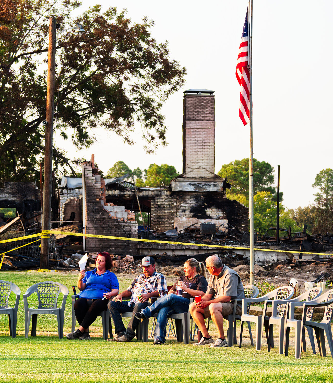 Employees, members and friends gathered on the first tee box just down the hill from the remains of the former clubhouse. [see how the club carries on]